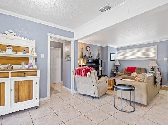 living room featuring crown molding and light tile patterned floors