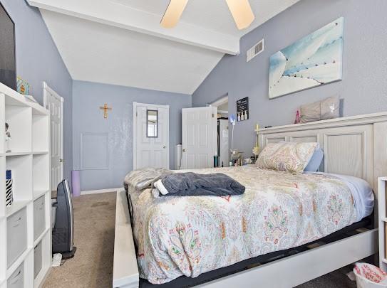 carpeted bedroom with ceiling fan and lofted ceiling with beams