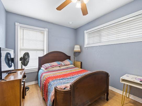 bedroom featuring light wood-type flooring and ceiling fan