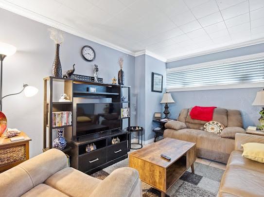 living room featuring crown molding and tile patterned flooring