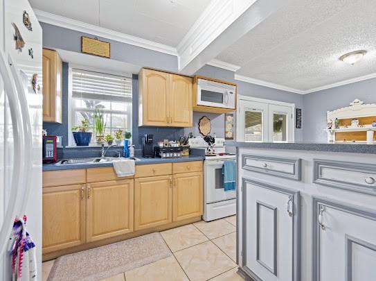 kitchen with light tile patterned flooring, ornamental molding, a textured ceiling, and white appliances