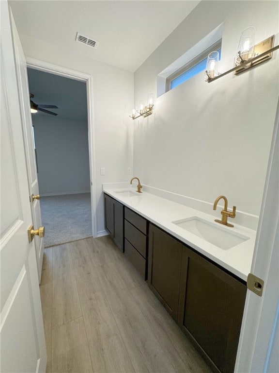 bathroom with vanity, ceiling fan, and wood-type flooring