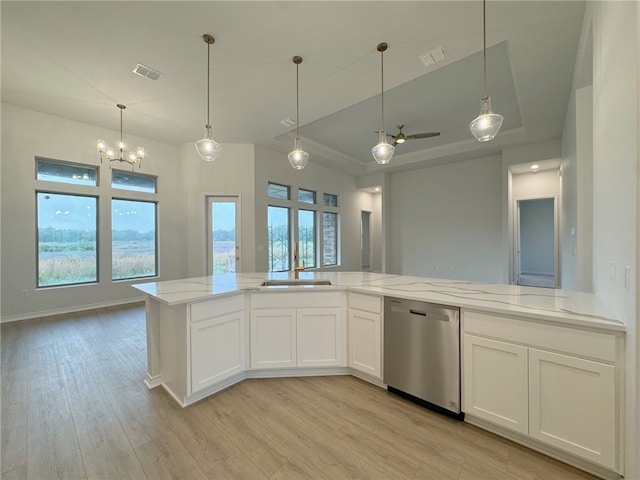 kitchen with light stone countertops, white cabinetry, sink, stainless steel dishwasher, and light hardwood / wood-style floors