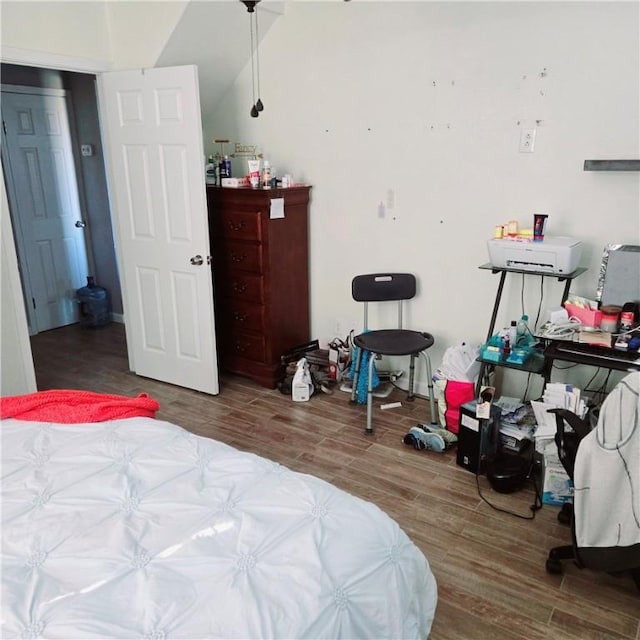 bedroom with wood finished floors and baseboards