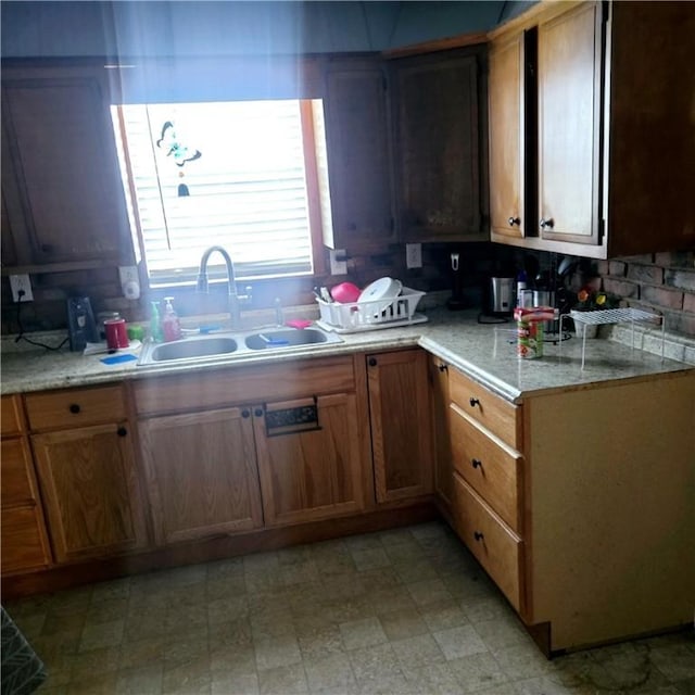 kitchen with light countertops, light floors, and a sink