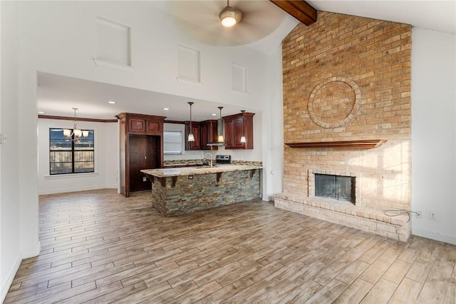 kitchen featuring kitchen peninsula, light hardwood / wood-style floors, and decorative light fixtures