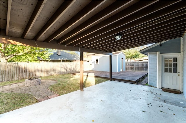 view of patio / terrace featuring a storage unit and a deck