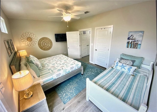 bedroom with ceiling fan and dark wood-type flooring