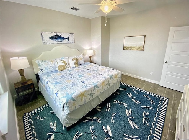 bedroom with ceiling fan and dark wood-type flooring