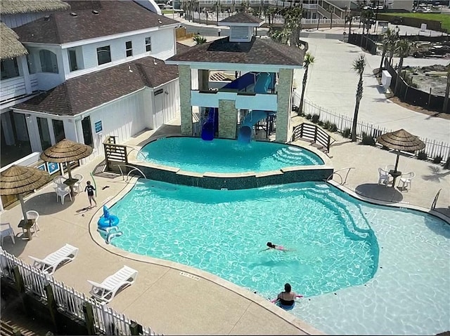 view of swimming pool featuring pool water feature and a patio