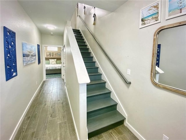 staircase with hardwood / wood-style flooring