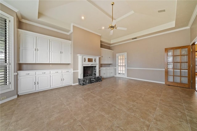 5305 Hunt Cir, Corpus Christi, TX 78413 - unfurnished living room with a ceiling fan, light tile patterned floors, a high end fireplace, ornamental molding, and a high ceiling
