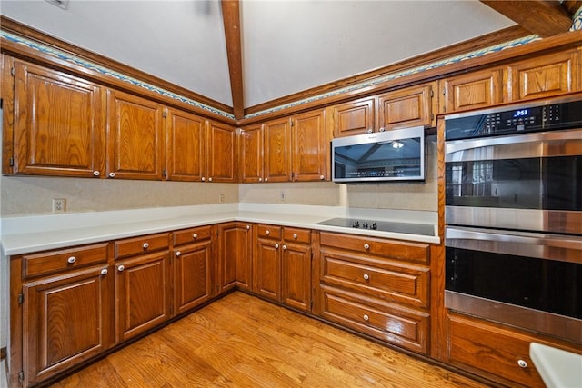 5305 Hunt Cir, Corpus Christi, TX 78413 - kitchen with stainless steel appliances, brown cabinetry, light wood-type flooring, and light countertops