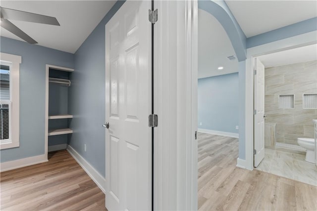 corridor with light hardwood / wood-style flooring