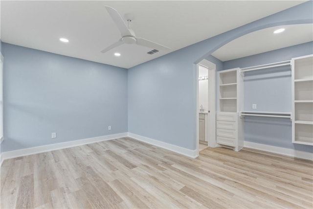 unfurnished bedroom featuring a closet, ceiling fan, and light wood-type flooring