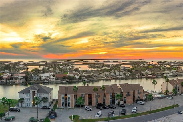 aerial view at dusk with a water view