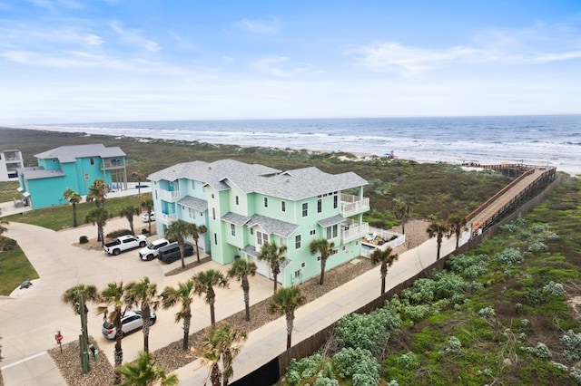 drone / aerial view featuring a beach view and a water view