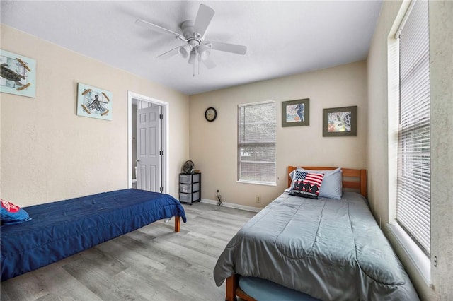 245 Griffith Dr, Rockport, TX 78382 - bedroom featuring baseboards, multiple windows, a ceiling fan, and wood finished floors