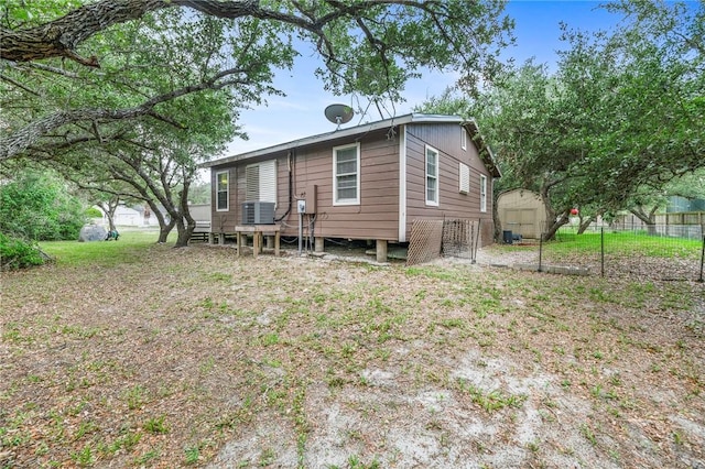 245 Griffith Dr, Rockport, TX 78382 - exterior space featuring fence, a storage unit, an outbuilding, and cooling unit