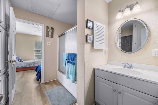 245 Griffith Dr, Rockport, TX 78382 - ensuite bathroom featuring vanity, ensuite bathroom, combined bath / shower with glass door, and wood finished floors