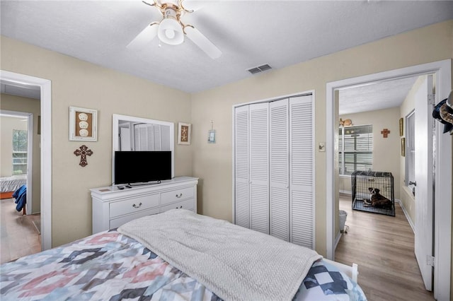245 Griffith Dr, Rockport, TX 78382 - bedroom featuring visible vents, a closet, wood finished floors, and multiple windows