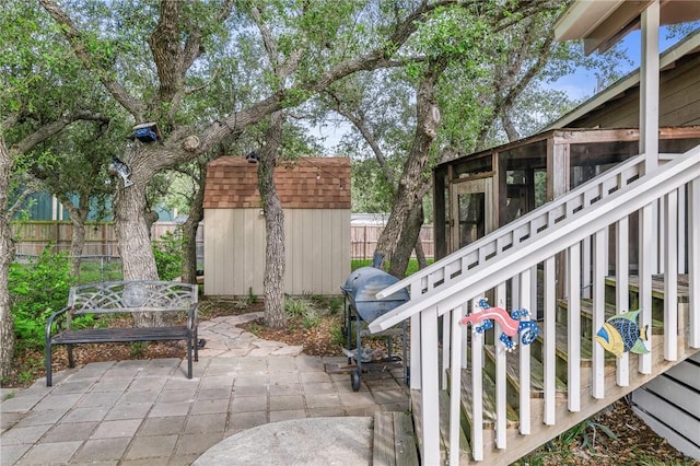 245 Griffith Dr, Rockport, TX 78382 - view of patio featuring a storage shed, a sunroom, an outdoor structure, and a fenced backyard