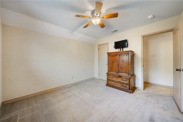 unfurnished bedroom with carpet flooring, baseboards, visible vents, lofted ceiling, and a ceiling fan