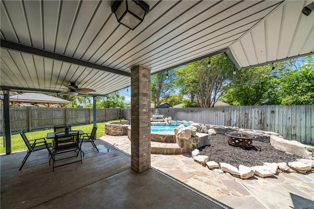 view of patio / terrace with a fire pit, a fenced in pool, a fenced backyard, and outdoor dining area