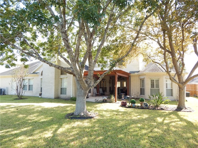 view of front of house with a front lawn, central AC, and a patio area