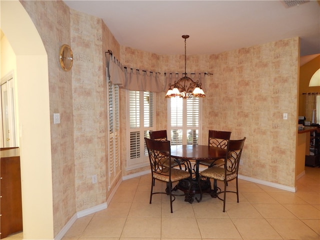 dining area with an inviting chandelier and light tile patterned flooring