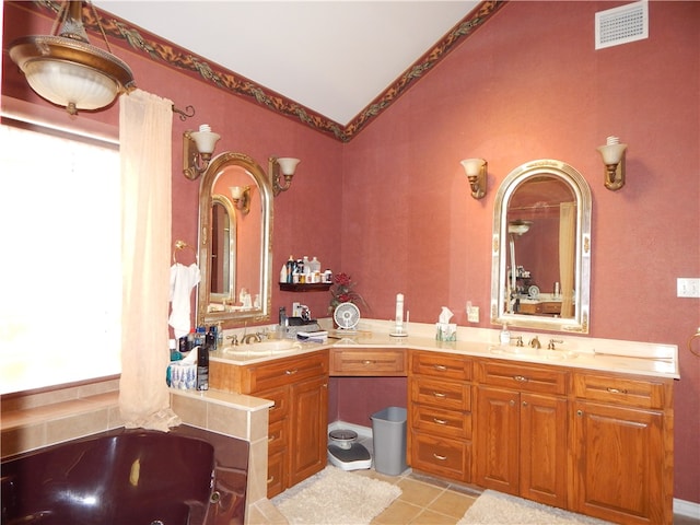 bathroom featuring a bath, tile patterned flooring, vanity, and lofted ceiling