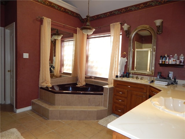 bathroom with tiled bath, vanity, and tile patterned floors