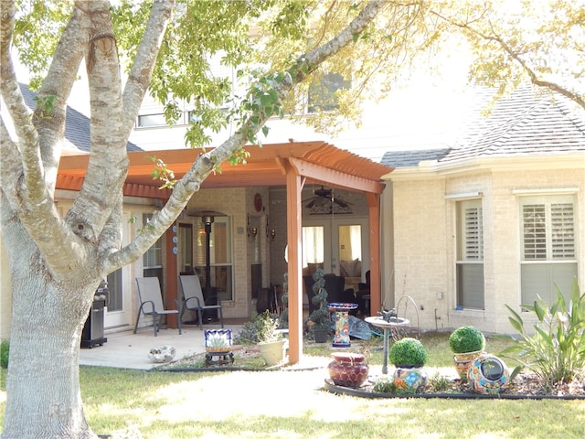 back of property with ceiling fan and a patio