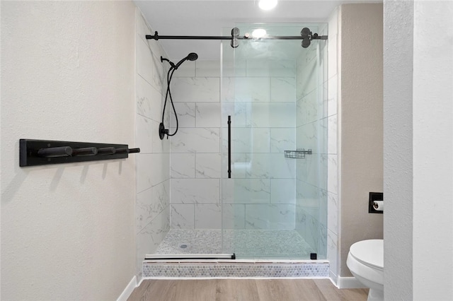 5973 State Highway 361 Unit 123, Port Aransas, TX 78373 - full bathroom featuring a stall shower, wood finished floors, and a textured wall