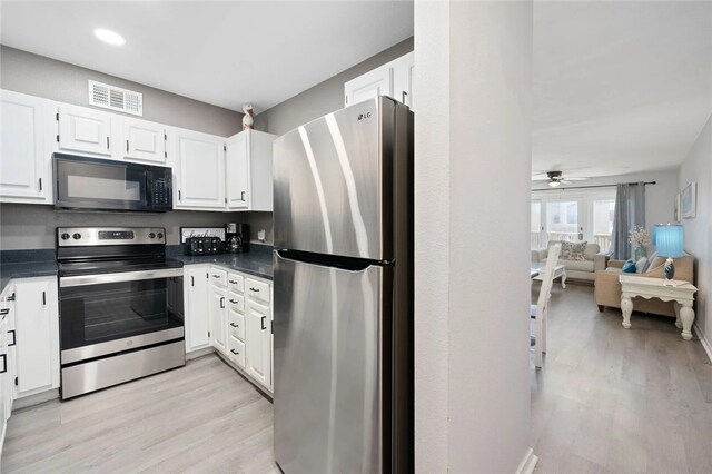 5973 State Highway 361 Unit 123, Port Aransas, TX 78373 - kitchen with stainless steel appliances, dark countertops, light wood finished floors, and recessed lighting