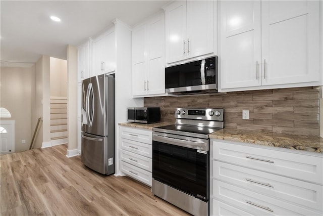 738 Crown Hbr, Corpus Christi, TX 78402 - kitchen featuring tasteful backsplash, light stone counters, appliances with stainless steel finishes, and white cabinets