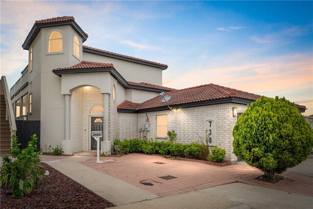 738 Crown Hbr, Corpus Christi, TX 78402 - mediterranean / spanish-style house featuring a tile roof, stucco siding, and brick siding