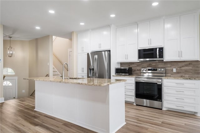 738 Crown Hbr, Corpus Christi, TX 78402 - kitchen with white cabinetry, a sink, appliances with stainless steel finishes, and an island with sink