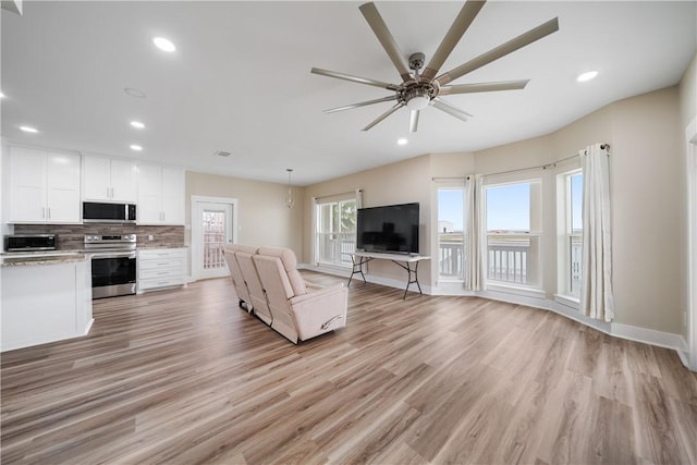 738 Crown Hbr, Corpus Christi, TX 78402 - unfurnished living room featuring baseboards, ceiling fan, recessed lighting, and light wood-style floors