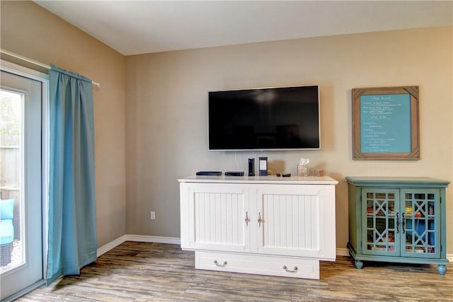 living room featuring baseboards and wood finished floors