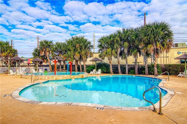 pool featuring fence, a patio, and a gazebo