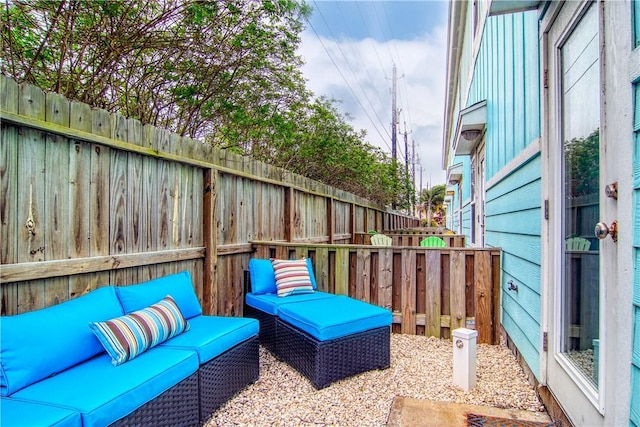 view of patio featuring fence and an outdoor living space