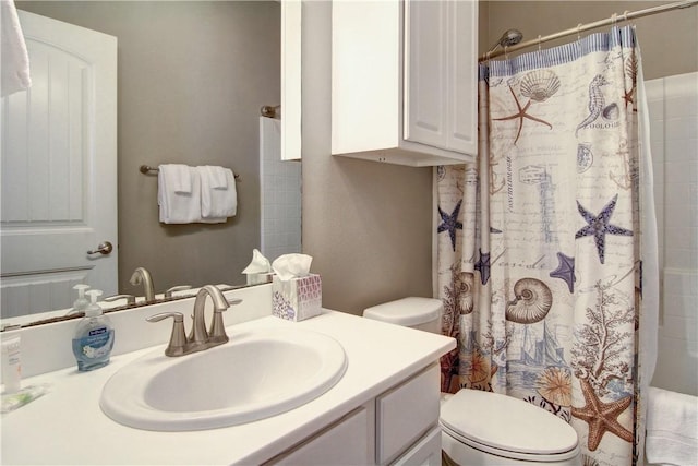bathroom featuring toilet, a shower with shower curtain, and vanity