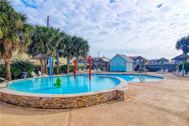 pool with a gazebo, fence, and a patio