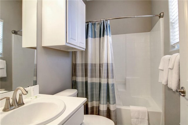 bathroom featuring a healthy amount of sunlight, vanity, toilet, and shower / bath combination with curtain
