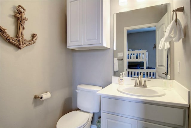 half bathroom featuring toilet and vanity