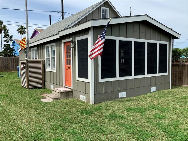 view of side of property with a lawn