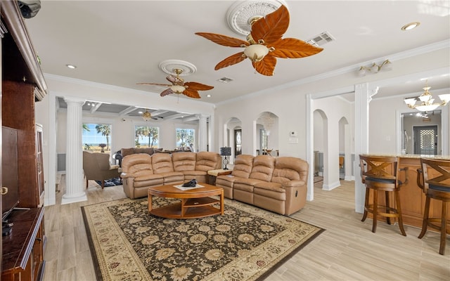 living room featuring light hardwood / wood-style floors, ornate columns, and ornamental molding