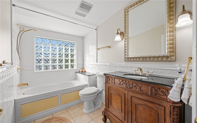 full bathroom featuring tile patterned floors, vanity, toilet, and tile walls