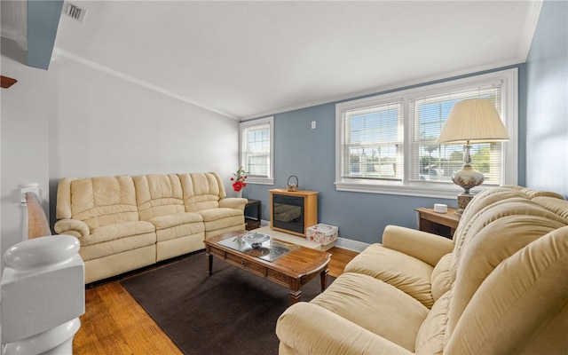 living room featuring crown molding and hardwood / wood-style flooring